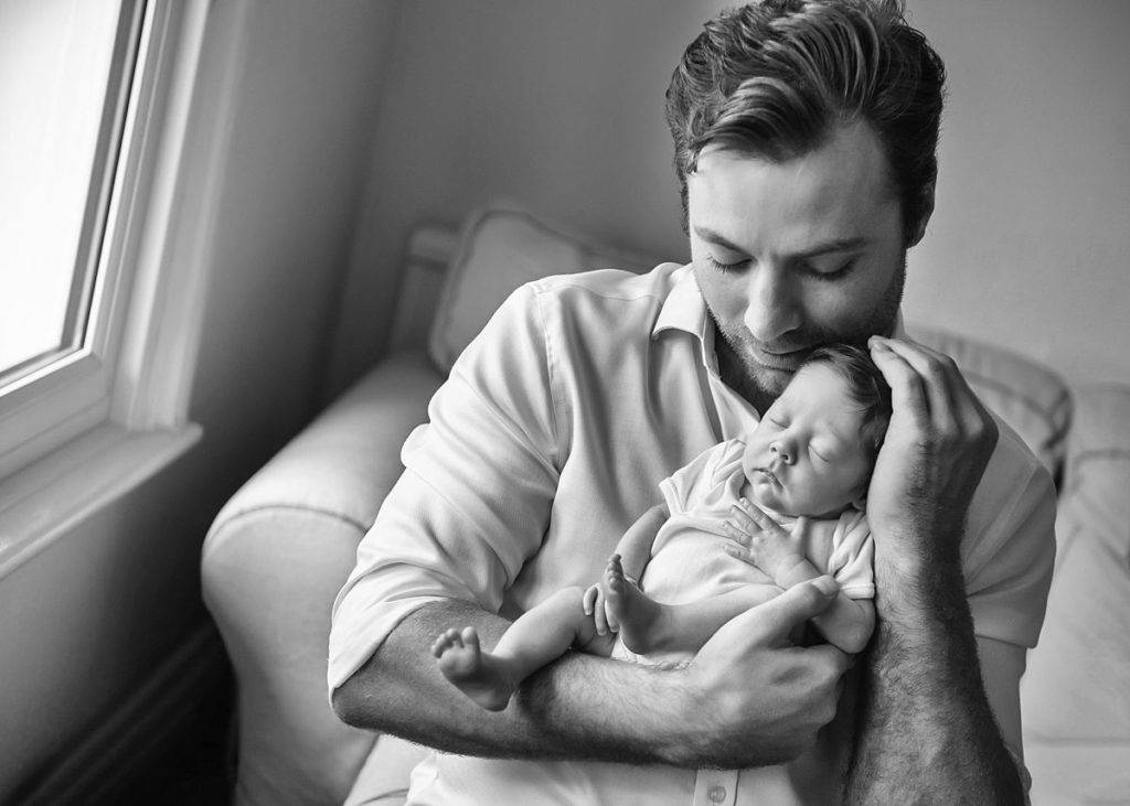 Newborn-Photography-Basingstoke-Winchester_0051 Father lovingly holding newborn baby during family newborn photoshoot Basingstoke Hampshire