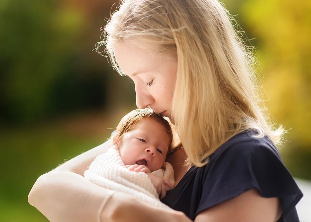 Newborn-Photography-Basingstoke-Winchester_0052 Mother kissing newborn baby during natural light newborn photography session Winchester