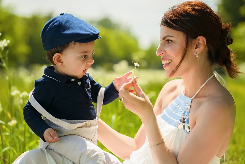 Mother and son playing in a meadow, captured candidly by a family photographer.