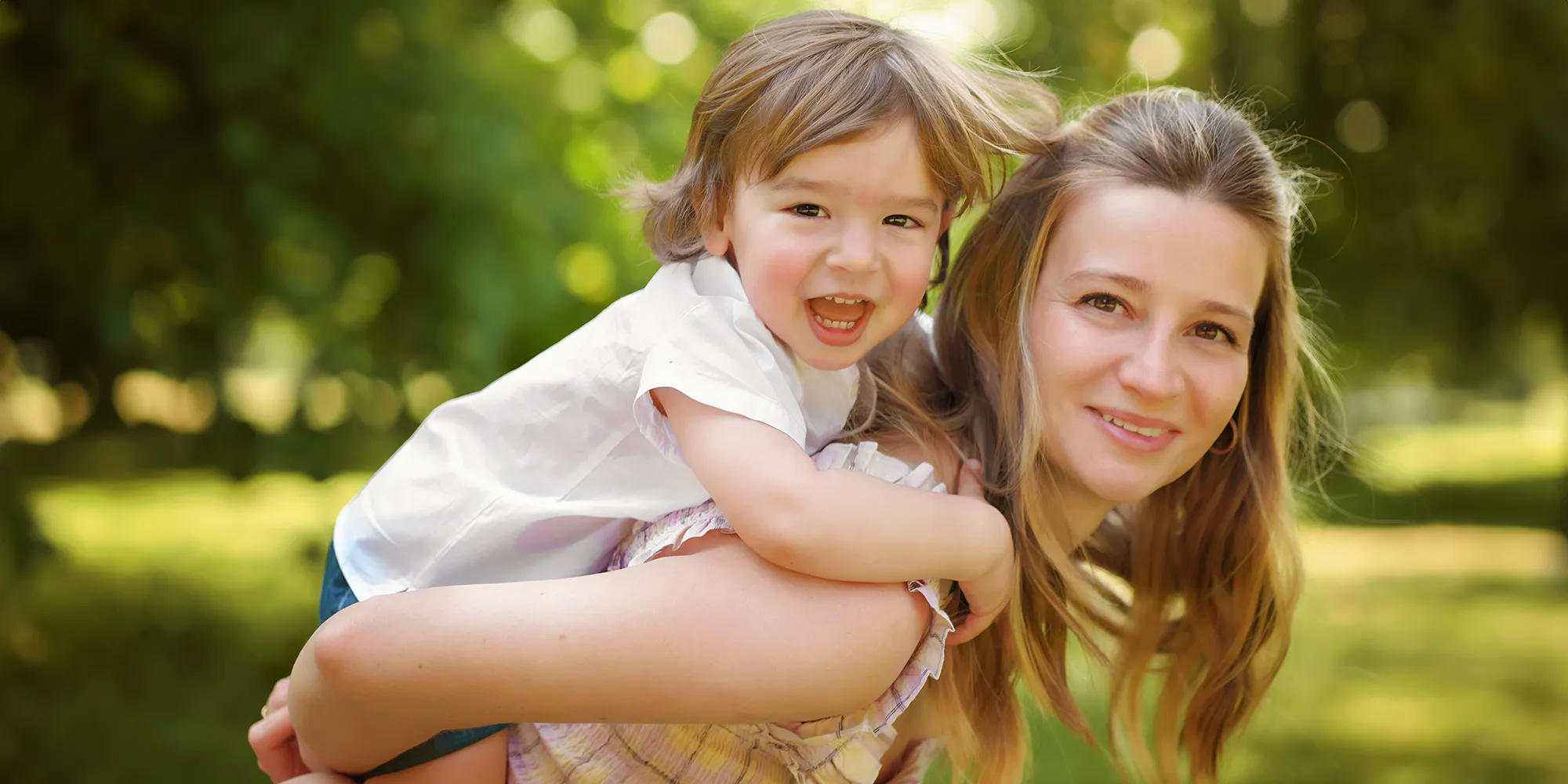 family portrait of mother and toddler son, captured in a park in Berkshire