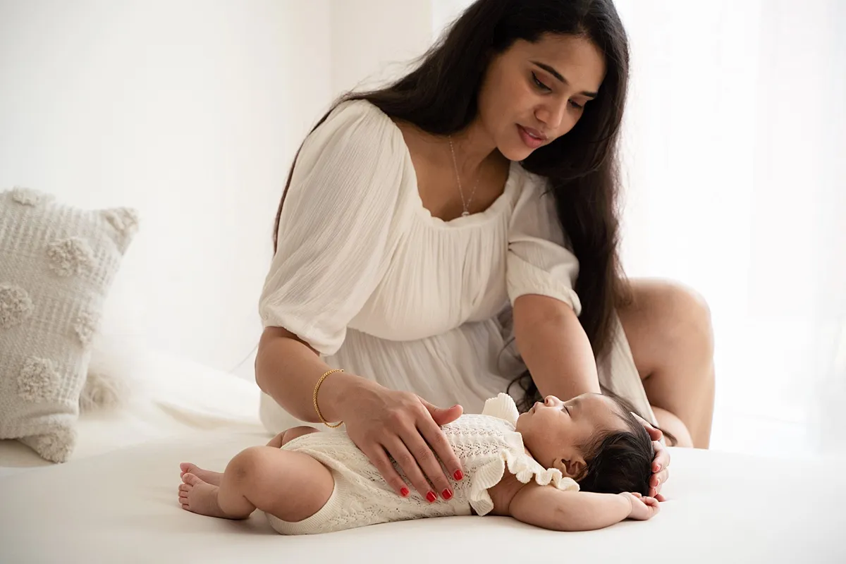 studio_newborn_photoshoot_0005_webp Mother gazing at newborn baby during natural light newborn photography session Basingstoke