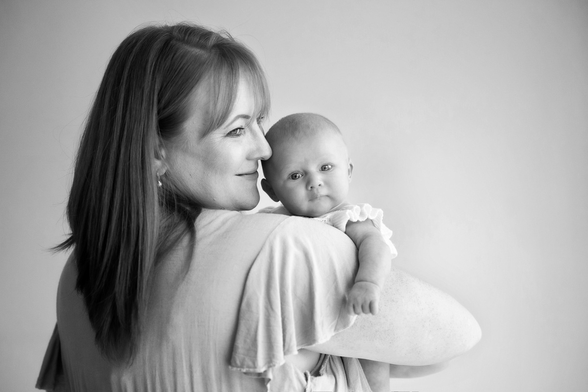 portrait of mother holding newborn baby, studio portrait in basingstoke