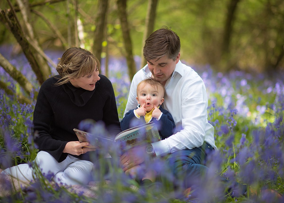Natural portrait of a toddler boy laying in a meadow of buttercups during a spring family shoot