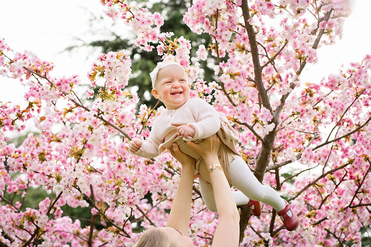 Natural portrait of a toddler boy laying in a meadow of buttercups during a spring family shoot