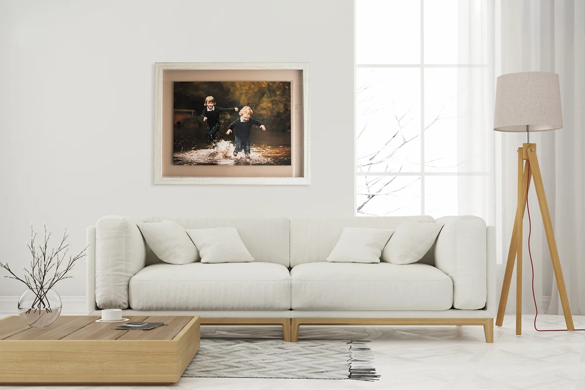 parents and siblings playing together in their living room during an in-home family photoshoot.