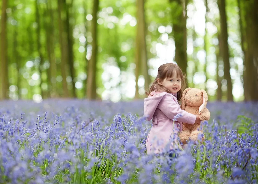 best_family_photoshoot_locations_0003_webp a natural portrait of a toddler girl in a bluebell meadow near Winchester, captured by portrait photographer Maria Cristina Licata