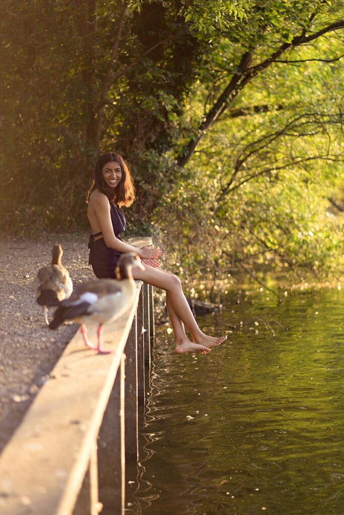 natural portrait of a girl sitting on a jetty looking at ducks at dinton pastures, taken by a reading family photographer