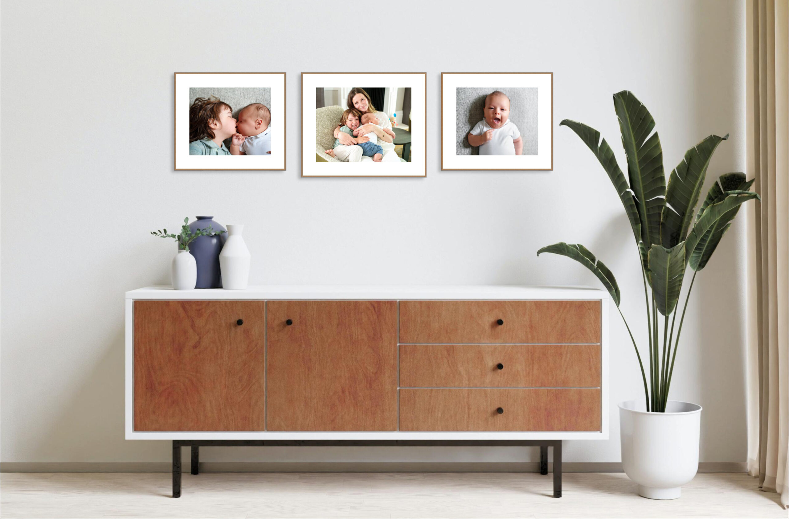 framed portrait gallery from a newborn photoshoot in a scandi style room with mid century sideboard